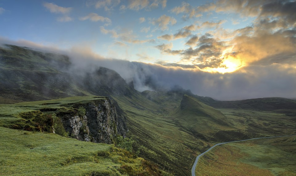 Low cloud moving through a green valley